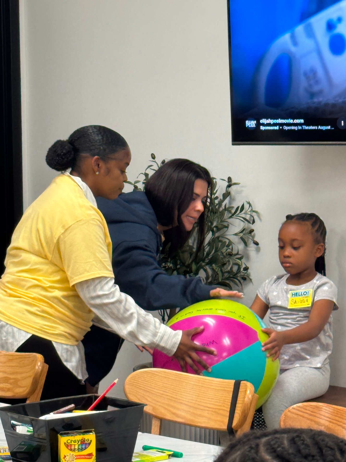 Mentors leading an icebreaker activity with a young girl