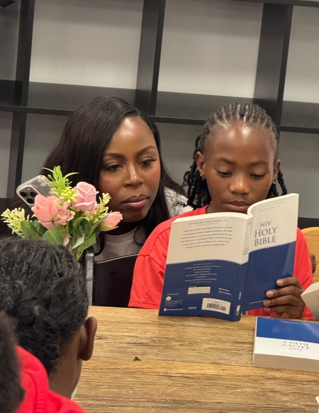 Girls reading the Bible together during Bible study